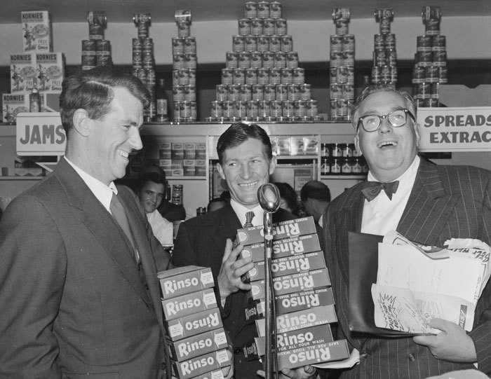 Admin_thumb_sir_edmund_hillary__selwyn_toogood__and_an_unidentified_man__with_give_away_rinso_products_at_the_opening_week_of_the_self_help_store__lambton_quay__wellington__1956
